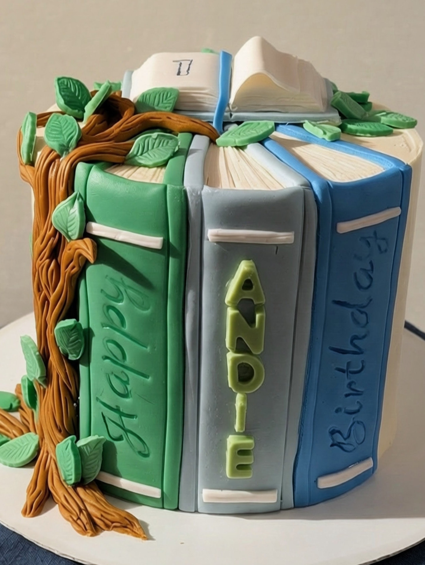 One in the books birthday cake with handmade fondant decorations and customer fondant topper